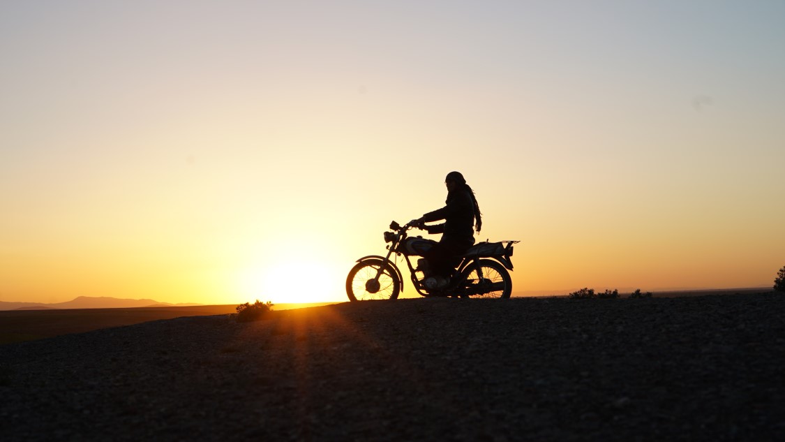 Silhouette of person on motorcycle
