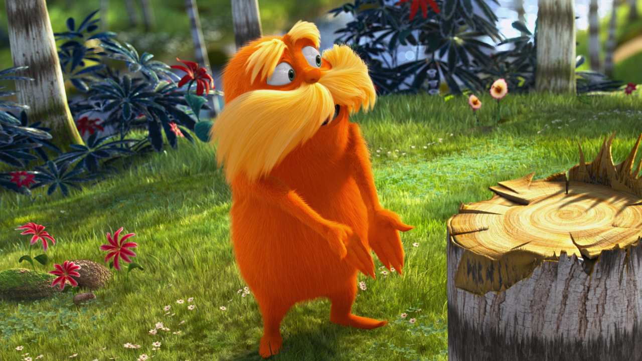 a furry orange creature next to a tree stump