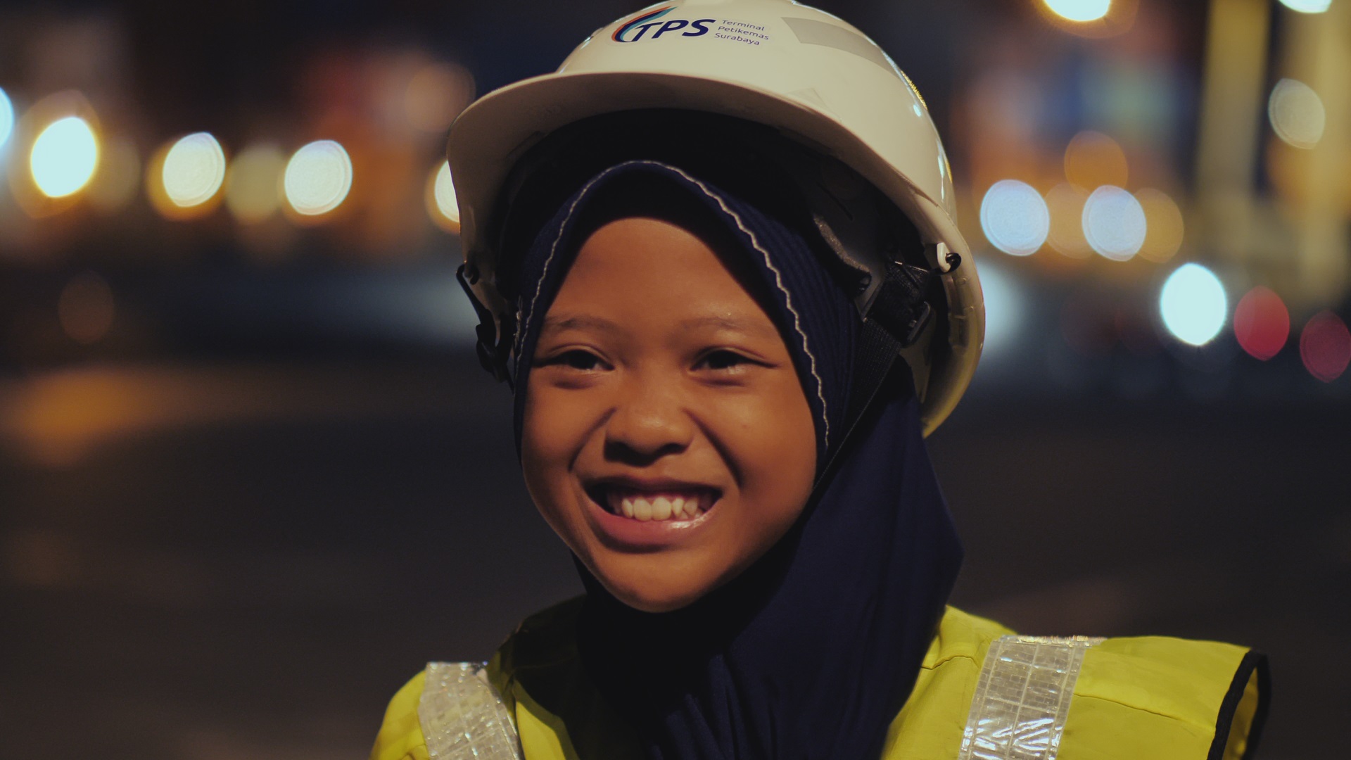 Young girl in hard hat smiling
