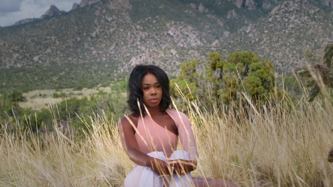 Black woman sitting in a field